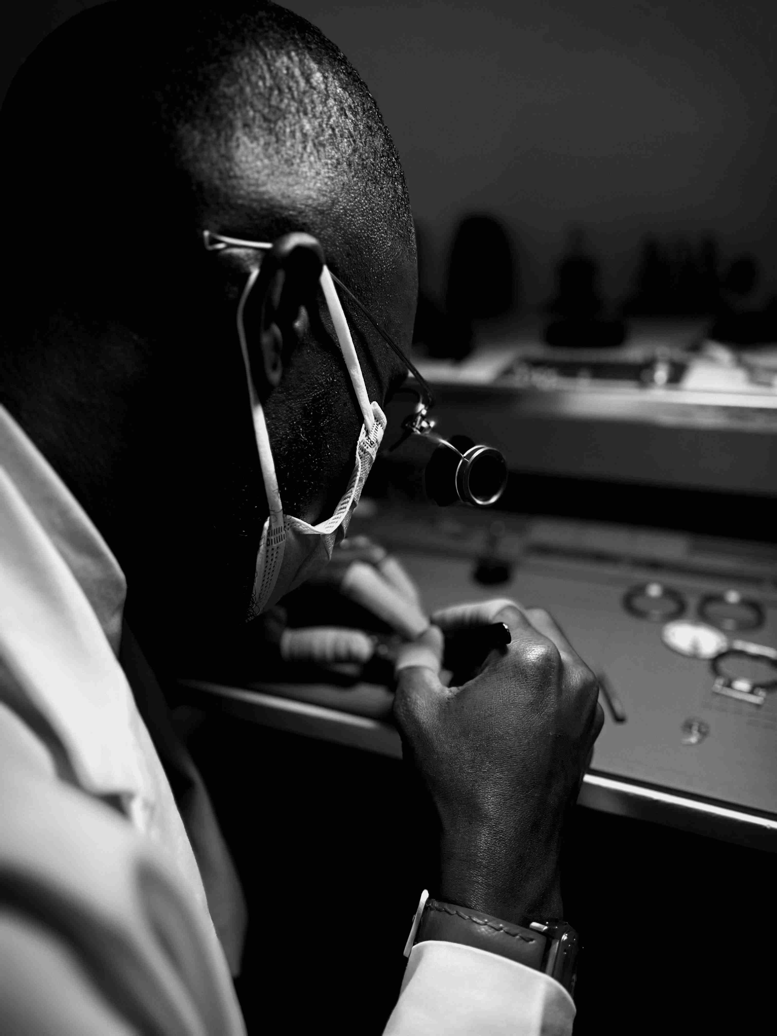 An optometrist carefully crafting a pair of eyeglasses with precision tools